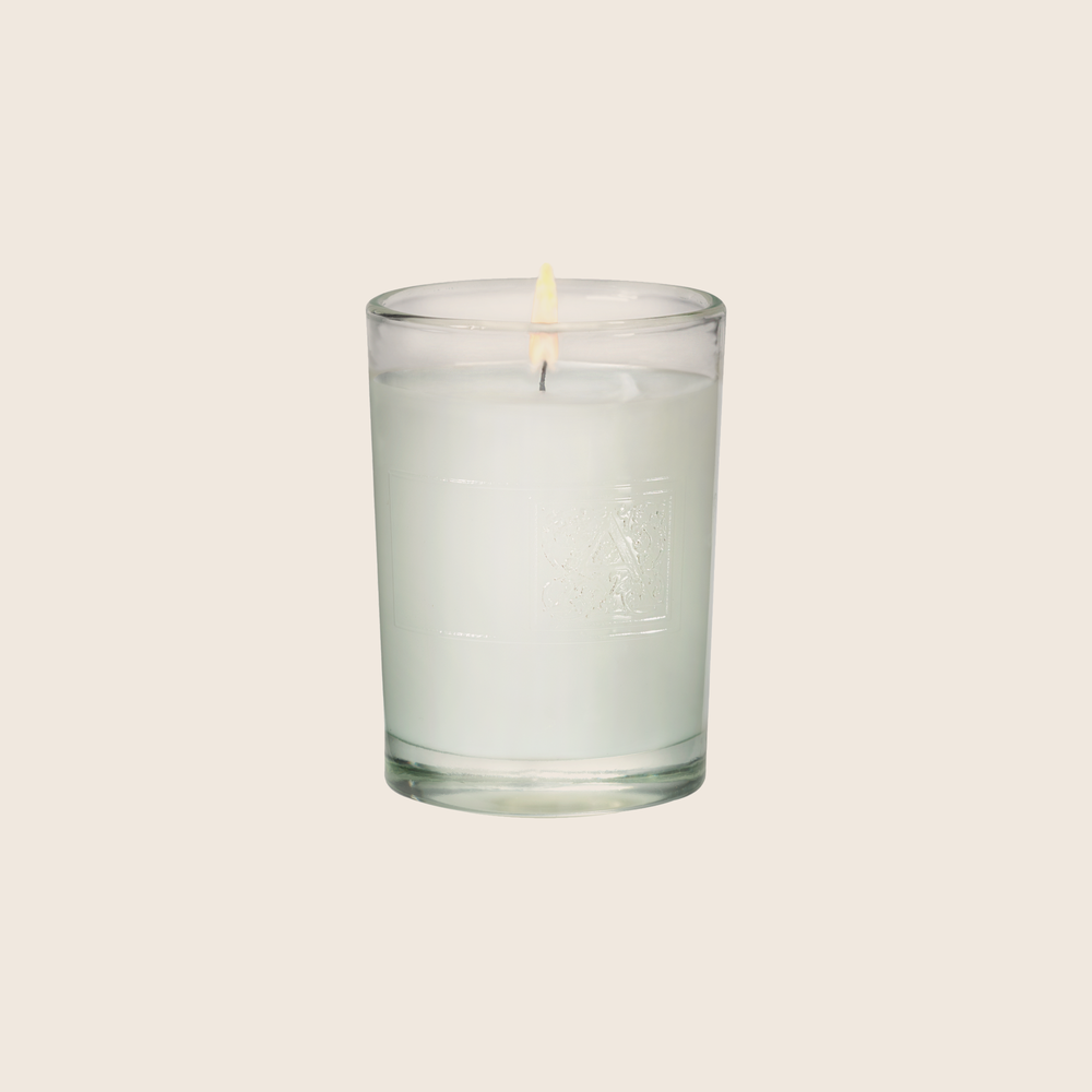 The White Teak & Moss Votive Candle is the perfect everyday scent with a clean fragrance of fresh citrus over notes of earthy moss, coconut, and sandalwood. Our candles are all hand-poured in Arkansas. Made with a proprietary wax blend, ethically sourced containers and cotton wicks. Light one of these aromatic candles and transport yourself to a memory or emotion.